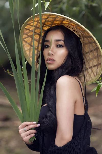 Young Sexy Vietnamese Girl In A Straw Hat In A Tropical Forest ⬇ Stock