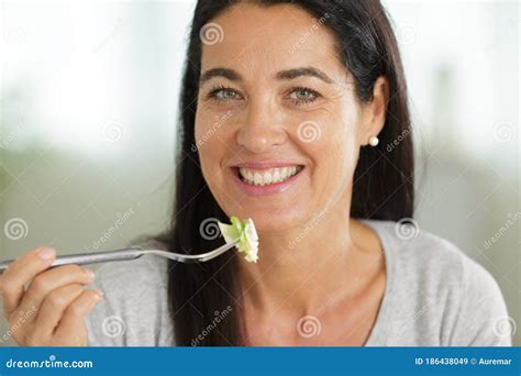 attractive mature woman eating salad stock image image of lifestyle athome 186438049