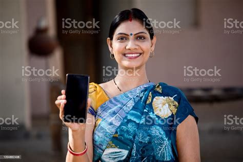 Indian Woman Showing Mobile Phone Stock Photo Download Image Now
