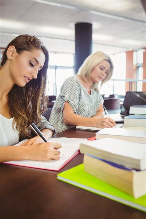 Matures Females Students Writing Notes At Desk Stock Photo Image Of