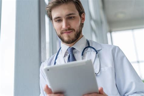 Male Medical Doctor Using Tablet Computer In Hospital Stock Image