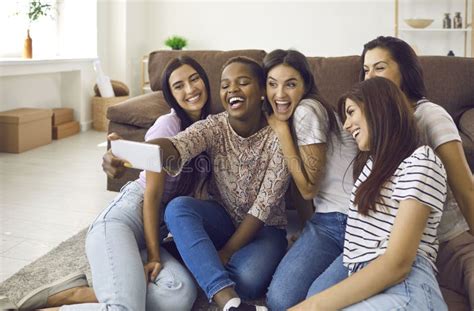 Company Of Multiracial Female Friends Have Fun And Take Selfies During