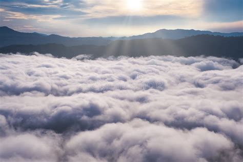 Aerial View Of Sunrise Above Fluffy Sea Fog Misty Clouds Stock Photo