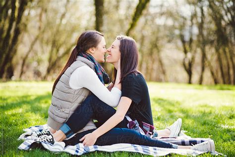 Lesbian Couple Embracing On A Blanket In The Park By Kate Ames