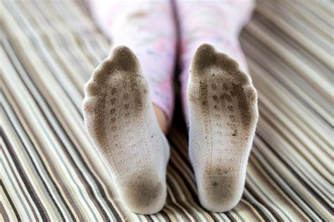 Pair Of Child Feet In Dirty Stained White Socks Kid Soiled