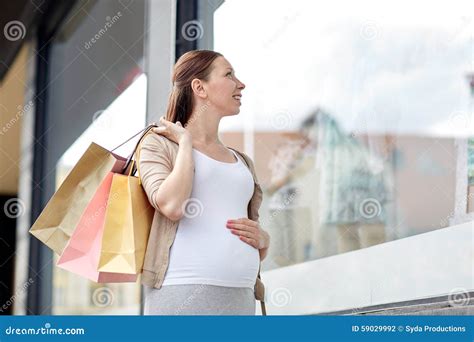 Happy Pregnant Woman With Shopping Bags At City Stock Photo Image Of