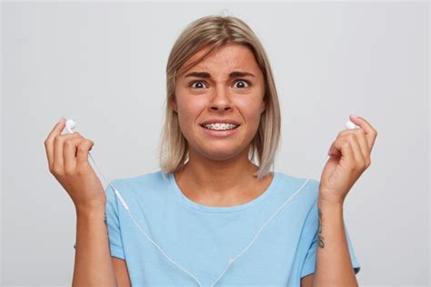 Free Photo Closeup Of Shocked Confused Blonde Young Woman Wears Blue