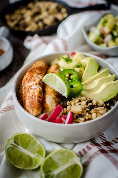 These blackened fish tacos are made with homemade seasoning and topped with cabbage slaw and a creamy chipotle sauce. Fish Taco Bowls with Plantain Rice and Pineapple Salsa