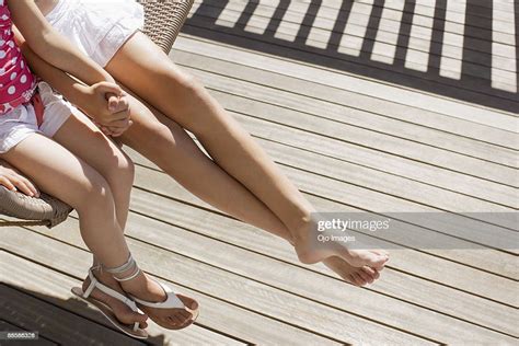 Girls Sitting In Porch Swing Photo Getty Images
