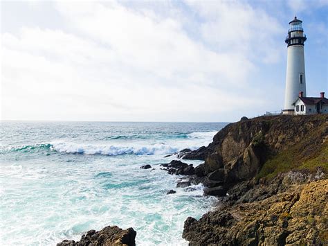 Royalty Free Photo House Beside Lighthouse Beside The Ocean During Day