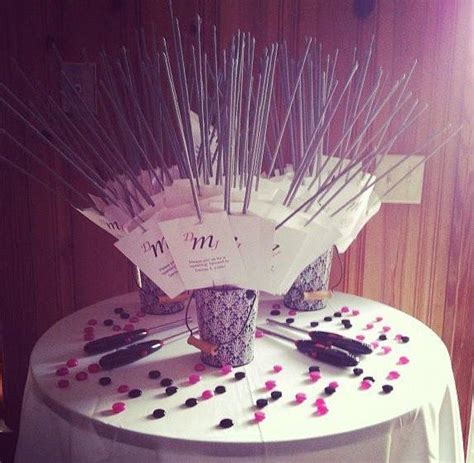 A Table Topped With Lots Of Sticks And Cups Filled With Confetti On Top