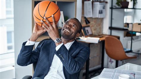 Sports Manager Handles Basketball While Sitting At His Desk