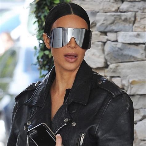 kim kardashian spotted wearing a black leather jacket with back to the future sunglasses while