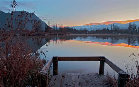 Wonderful Reflection On A Still Lake Piers Mountains Sunset