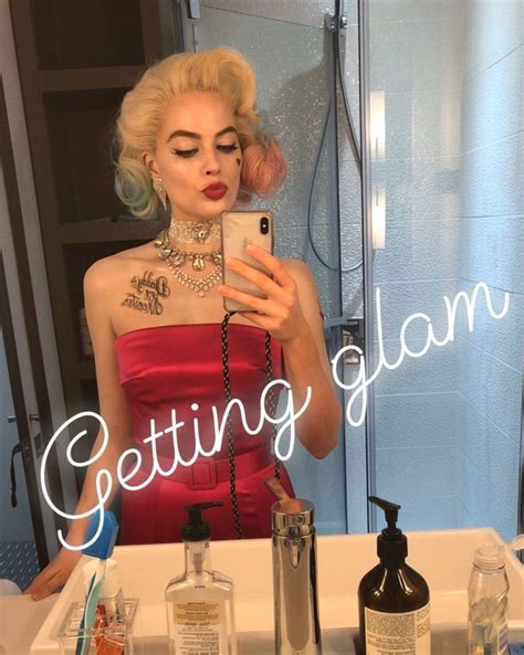 A Woman Taking A Selfie In Front Of A Bathroom Mirror With The Words Getting Glam Written On It