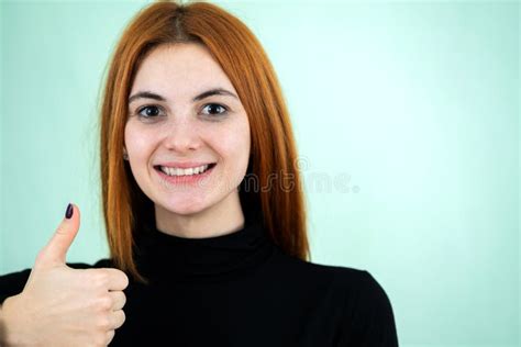 Funny Pretty Redhead Girl Showing Thumbs Up Sign With Her Fingers Stock