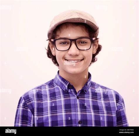 Portrait Of Smart Looking Arab Teenager With Glasses Wearing A Hat In