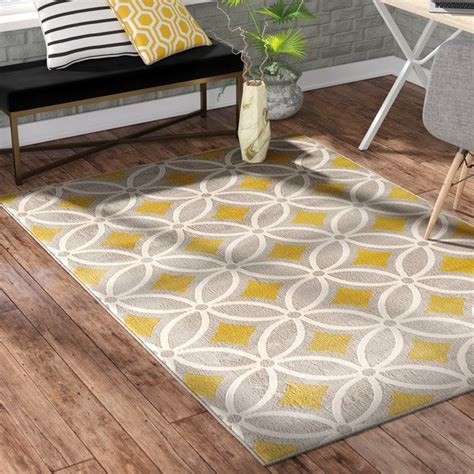 A Yellow And Gray Area Rug In A Living Room