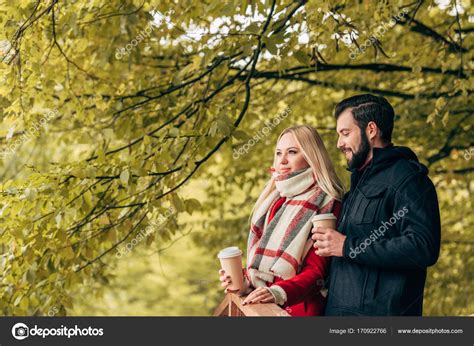 Couple Drinking Coffee In Park — Stock Photo © Alexlipa 170922766
