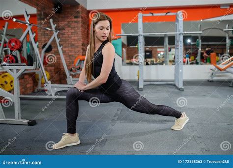 Portrait Of Fitness Woman Stretching At Gym Before Workout Leg