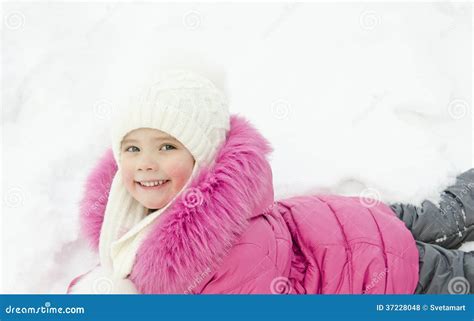Smiling Little Girl Lying In Snow Stock Photo Image Of December