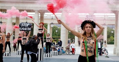 topless feminist protestors bring paris to standstill in nude action against male violence