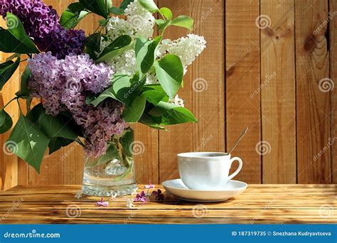 Still Life A Bouquet Of Lilacs With A Cup Of Tea In The Early Morning