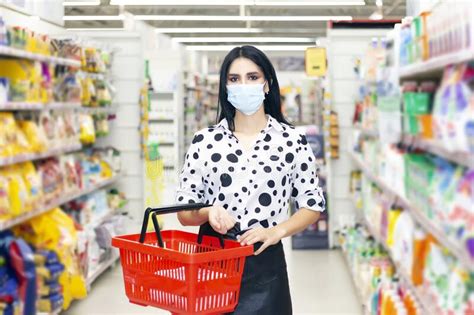 Young Woman In A Disposable Medical Mask Is Shopping At The Supermarket Stock Image Image Of