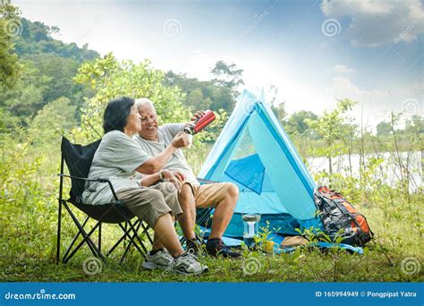 The Old Couple Camping In The Forest To Relax In Retirement Stock Image