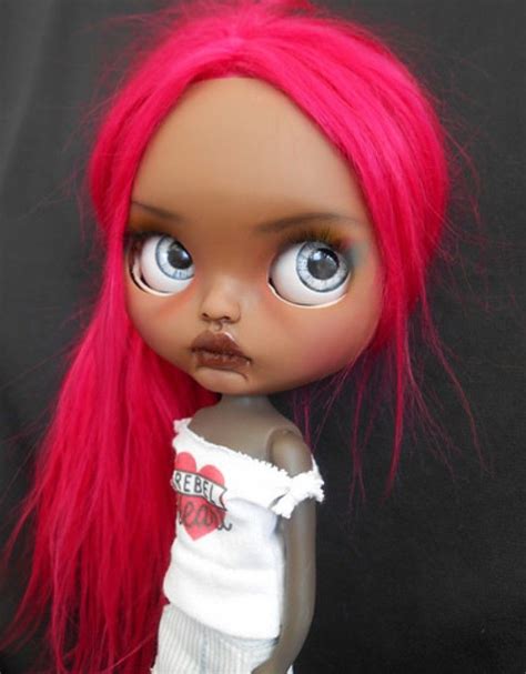 a doll with pink hair and blue eyes