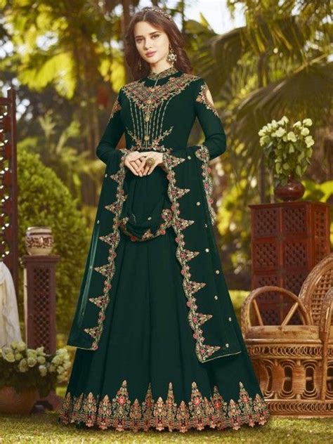 Anarkalis are long gown style dresses that are generally bell shaped, worn with pants and have a matching dupatta. Pristine green partywear gown suit online which is crafted ...