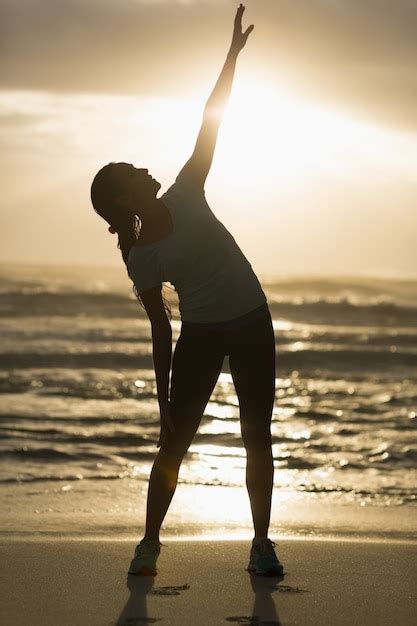 Premium Photo Sporty Brunette Stretching On The Beach