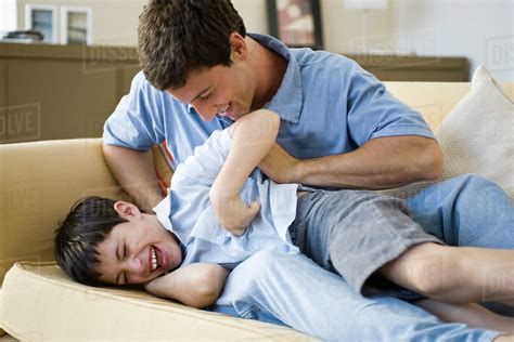 Father Tickling Young Son Stock Photo Dissolve