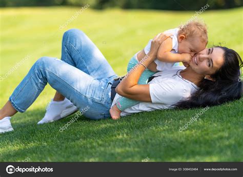 웃는 즐거운 젊은 어머니는 그녀의 아이를 껴안고 — 스톡 사진 © vaicheslav 308402464