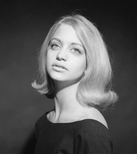 A Black And White Photo Of A Woman With Blonde Hair Looking Off To The Side