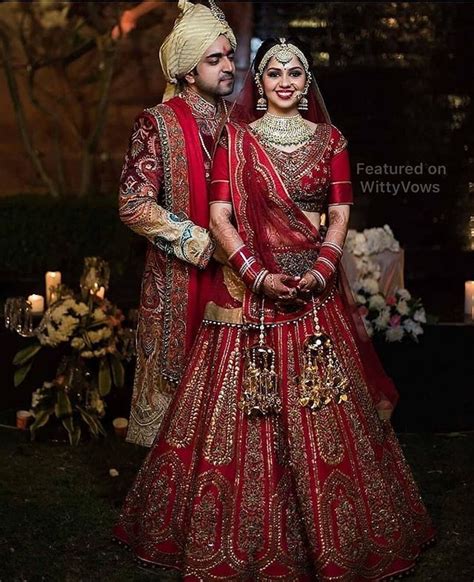 beautiful indian couples bride and groom in matching outfits red leh… indian wedding
