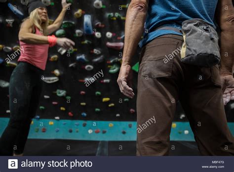 Female Rock Climber Gesturing Talking With Male Rock Climber At