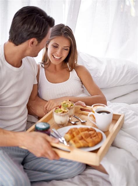 Nothing Better Than Breakfast In Bed A Loving Young Couple Enjoying Breakfast In Bed Stock