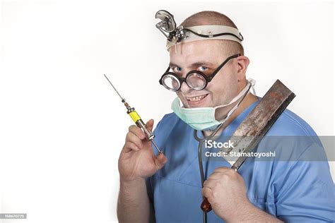 Crazy Doctor With A Syringe And Rusty Bonesaw Stock Photo Download