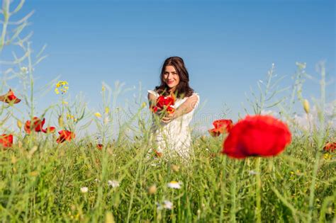beauty woman in poppy field in white dress holding a poppies bouquet stock image image of