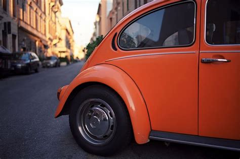 Orange Volkswagen Beetle Coupe Parked Diagonally Side Road