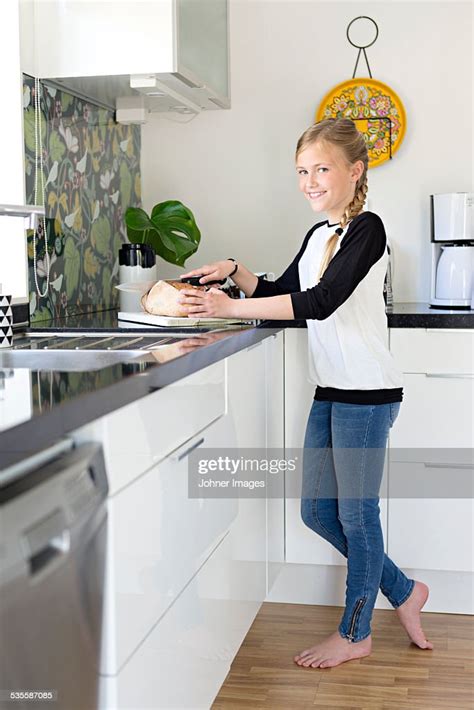 Girl Cutting Bread In Kitchen Photo Getty Images