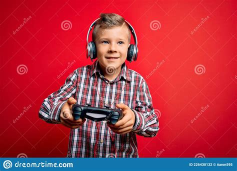 Adorable Blond Gamer Toddler Smiling Happy And Confident Stock Photo