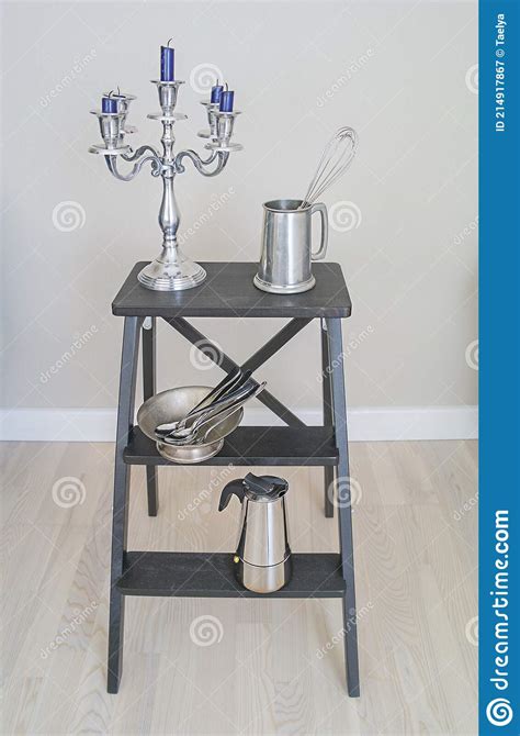 Set Of Metal Household Items On A Black Bookcase Stock Image Image Of