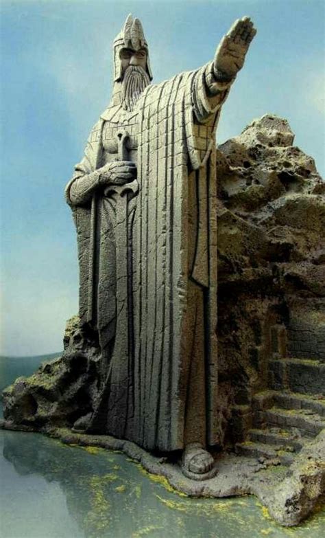 A Statue Of A Man With A Beard And Holding A Staff Standing In Front Of
