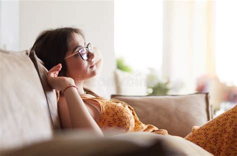 Relaxed Woman Sitting On A Modern Sofa At Home Stock Image Image Of