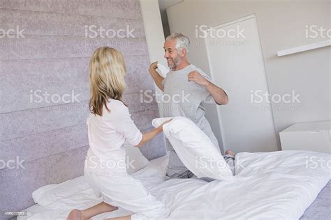 Silly Couple Having A Pillow Fight Stock Photo Download Image Now