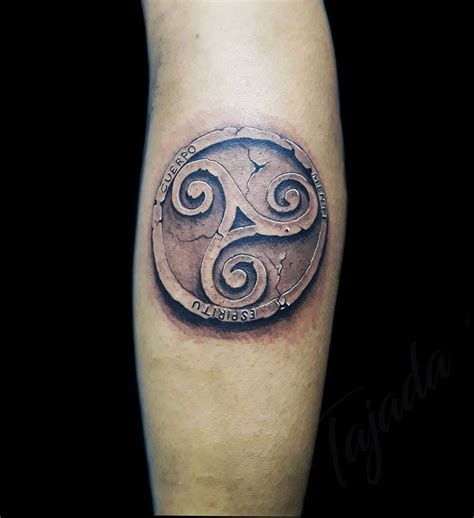 A Mans Leg With A Tattoo On It That Has An Image Of A Celtic Symbol