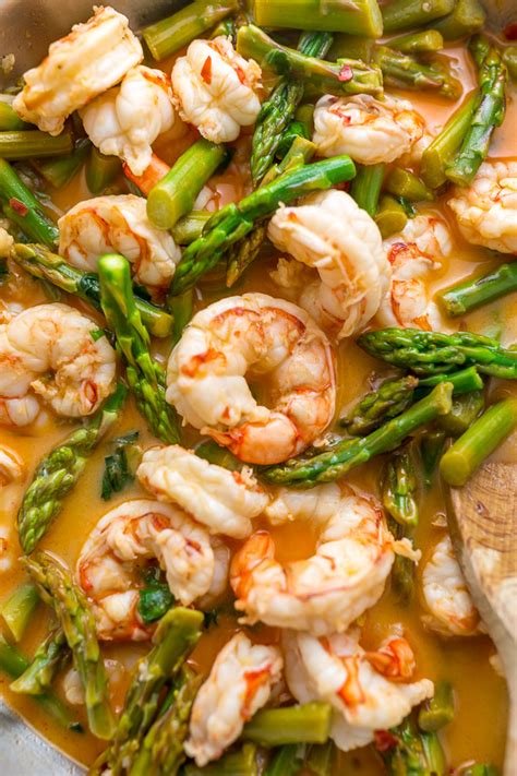 While the asparagus is roasting, add the peeled shrimp, melted butter, garlic, and paprika to a large bowl. Lemon Garlic Shrimp and Asparagus - Baker by Nature