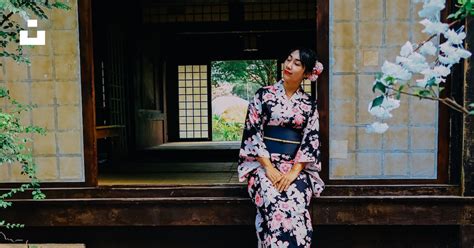 Woman In Blue White And Red Floral Kimono Standing On Sidewalk During